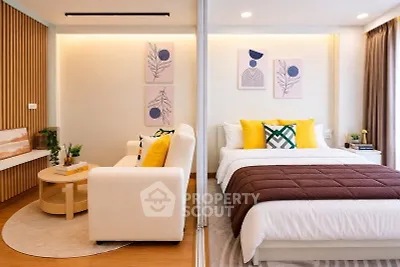 Modern studio apartment with cozy living area and stylish bedroom decor