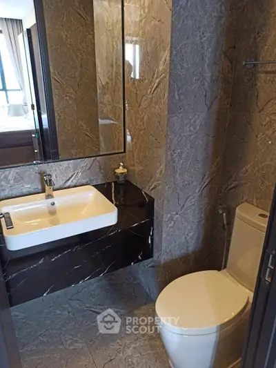 Modern bathroom with sleek marble finishes and contemporary fixtures