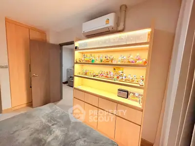 Spacious bedroom with built-in shelving and air conditioning, perfect for modern living.