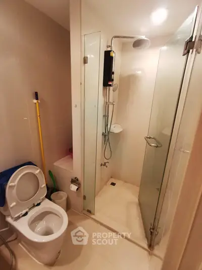 Modern bathroom with glass shower enclosure and sleek fixtures