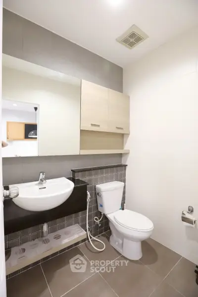 Modern bathroom with sleek fixtures and stylish tiles in a contemporary apartment.