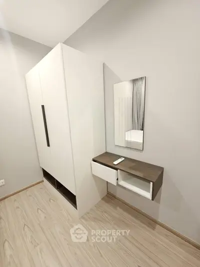 Modern bedroom with sleek wardrobe and stylish vanity in minimalist design