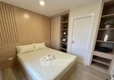 Modern bedroom with wooden accents and built-in shelves, featuring a cozy bed and soft lighting.