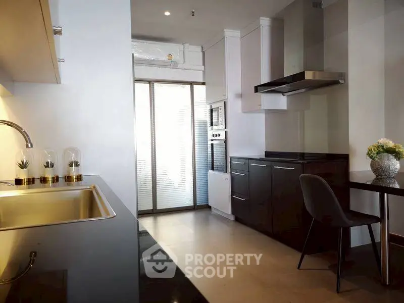 Modern kitchen with sleek black countertops and built-in appliances