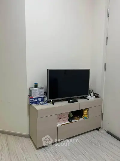 Cozy living room corner with modern TV stand and sleek flooring