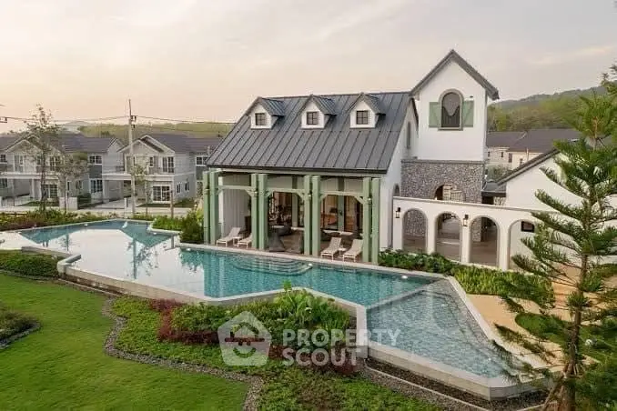 Luxurious villa with stunning pool and lush garden in serene neighborhood.