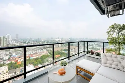 Stunning high-rise balcony with panoramic city views and modern outdoor seating.