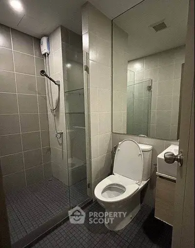 Modern bathroom with glass shower and sleek tile design