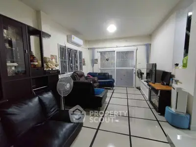 Spacious living room with modern furniture and tiled flooring