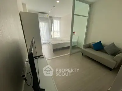 Modern apartment with glass partitioned bedroom and cozy living area