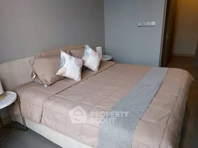 Modern bedroom with stylish decor and comfortable bedding in a cozy apartment.