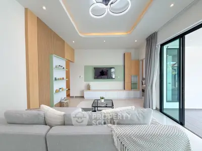 Modern living room with sleek design, large windows, and stylish lighting in a contemporary home.