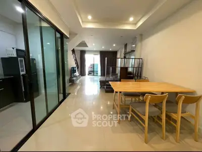 Spacious open-plan living and dining area with modern kitchen and stylish decor.