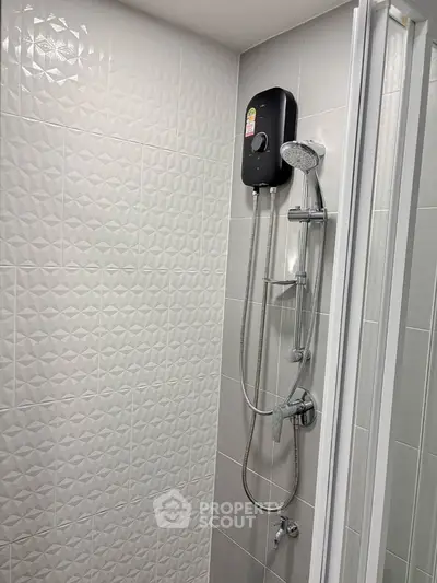 Modern bathroom with sleek shower fixtures and textured wall tiles