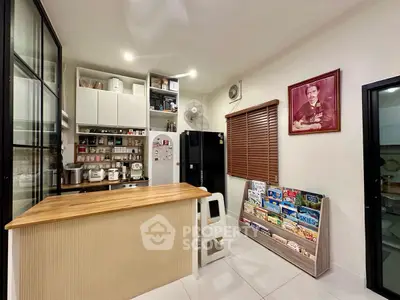 Charming kitchen with open shelving and cozy breakfast bar, perfect for modern living.