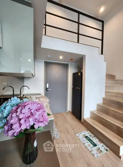 Modern duplex apartment with stylish kitchen and wooden staircase