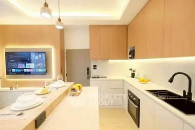 Modern kitchen with sleek design, built-in appliances, and ambient lighting