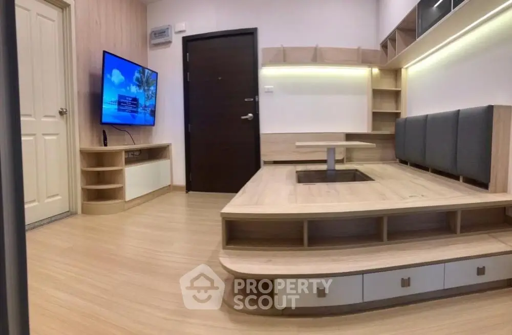 Modern living room with built-in seating and wall-mounted TV, featuring stylish wood flooring and ambient lighting.