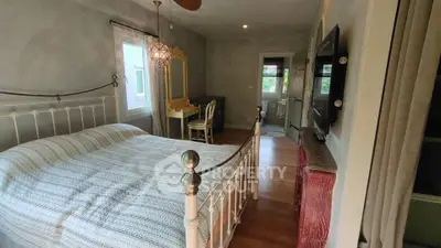 Charming bedroom with vintage decor and ample natural light