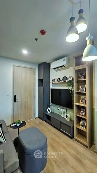 Modern living room with stylish decor and cozy seating in a contemporary apartment.