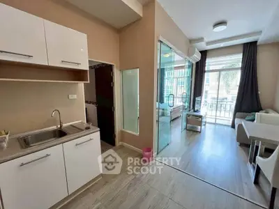 Modern open-layout apartment with glass partition and balcony view