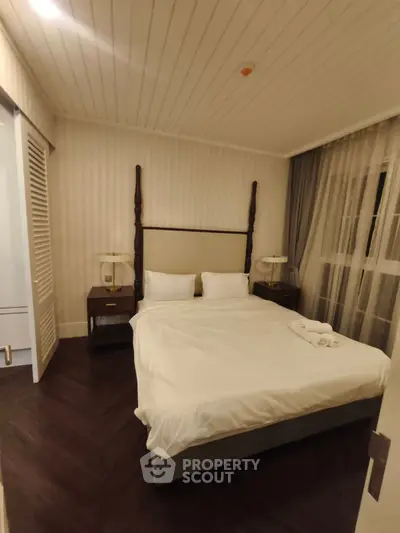 Elegant bedroom with cozy lighting and classic decor, featuring a comfortable bed and stylish nightstands.