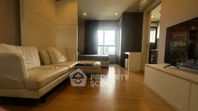 Modern open-plan living room with cozy seating and natural light, perfect for relaxation and entertainment.
