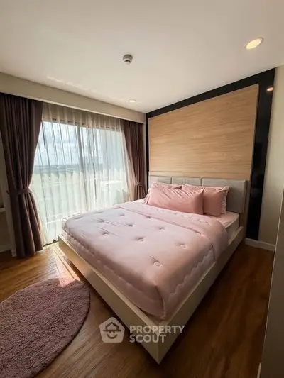 Cozy bedroom with large window and stylish decor in modern apartment