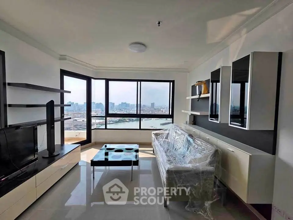 Spacious living room with panoramic city view and modern furnishings