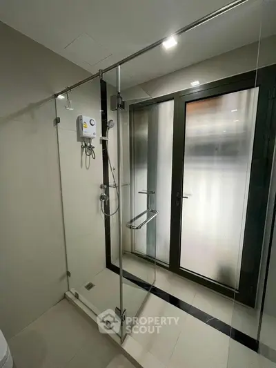 Modern bathroom with glass shower enclosure and frosted glass door