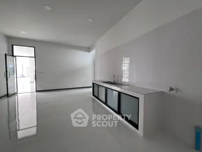 Spacious modern kitchen with sleek countertops and ample natural light
