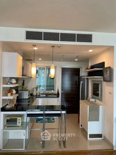 Modern kitchen with open layout and sleek appliances in a stylish apartment