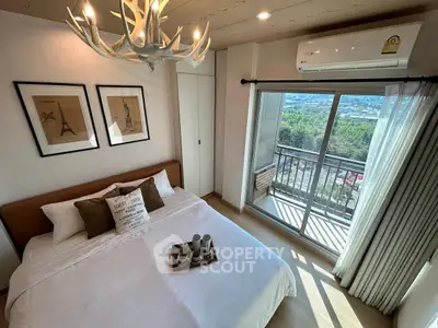 Modern bedroom with balcony view, stylish decor, and natural light