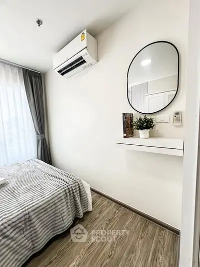 Modern bedroom with air conditioning and stylish decor in a cozy apartment.