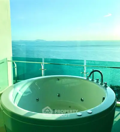 Luxurious balcony with jacuzzi offering stunning ocean view, perfect for relaxation and leisure.