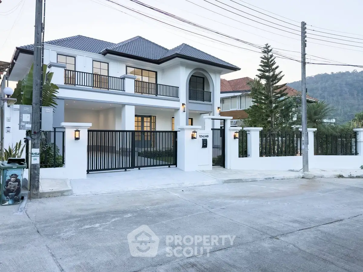 Luxurious two-story house with modern design and spacious driveway in a serene neighborhood.