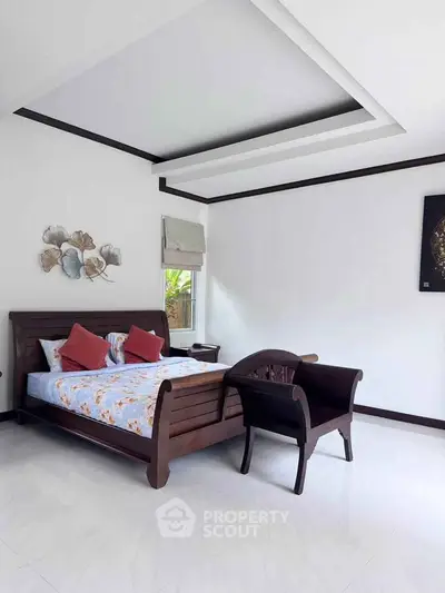 Spacious bedroom with elegant wooden furniture and modern decor