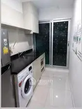 Modern kitchen with sleek appliances and glossy white tiles