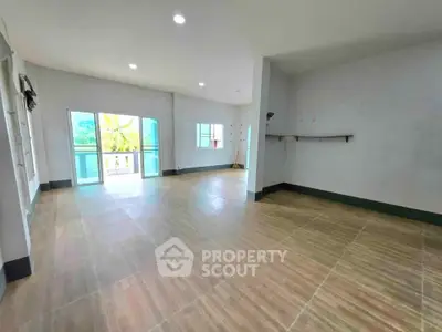 Spacious empty room with large windows and tiled flooring, ideal for customization.