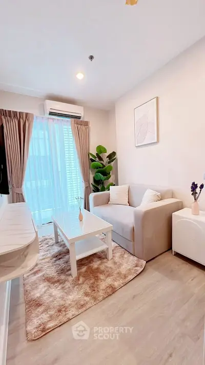 Chic modern living room with cozy sofa, stylish decor, and natural light.