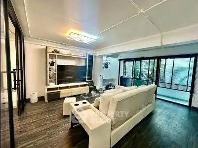 Spacious modern living room with sleek design and large windows for natural light.