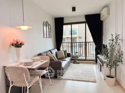 Chic modern living room with balcony view, stylish decor, and cozy seating area.