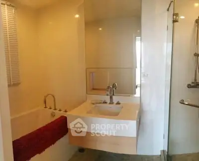 Modern bathroom with sleek fixtures and glass shower enclosure