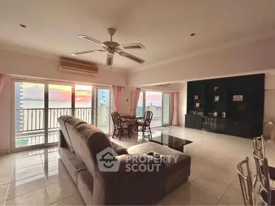 Spacious living room with stunning ocean view and large balcony access.