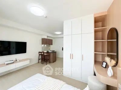 Modern studio apartment with sleek design, featuring built-in storage and cozy living area.