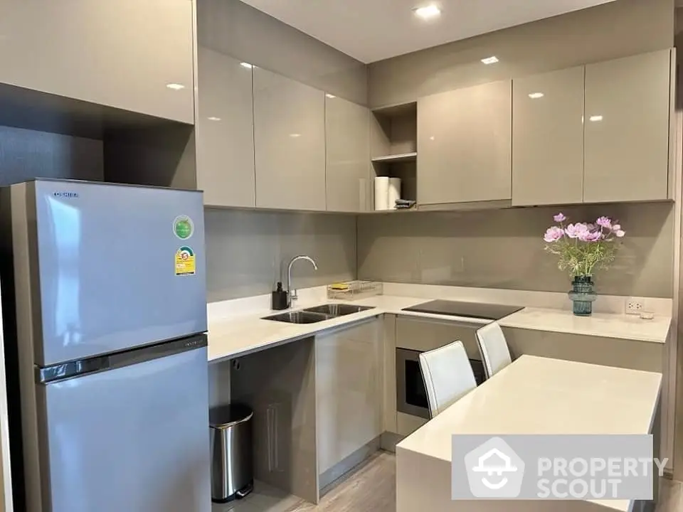 Modern kitchen with sleek cabinets and built-in appliances in a stylish apartment.