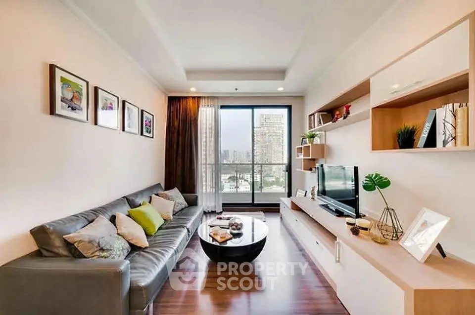 Modern living room with stylish decor and city view, featuring a sleek sofa and entertainment unit.