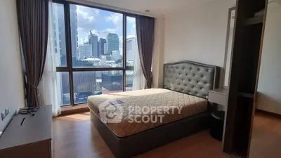 Spacious bedroom with city view and modern furnishings