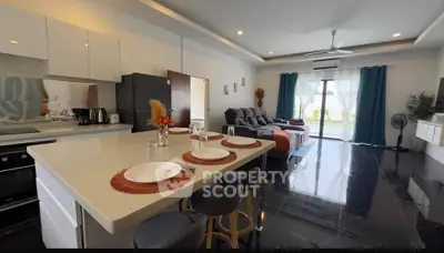 Spacious open-plan living room with modern kitchen and stylish decor