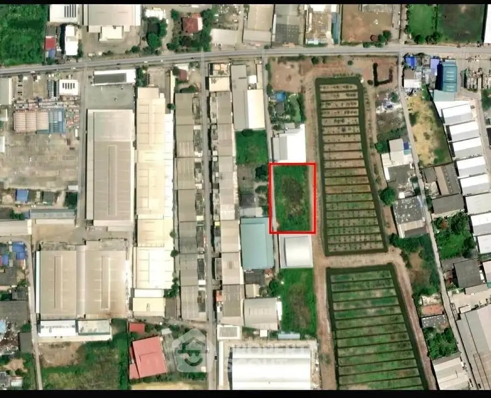 Aerial view of industrial area with highlighted plot for potential development.